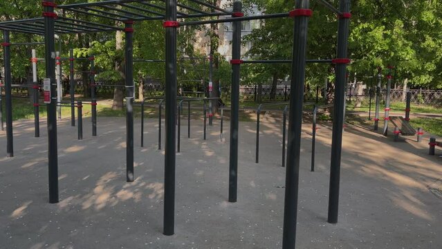An empty sports field in a Moscow park by summer day. Chinning bars, sports equipment, crossbars