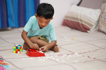 Attentive Young Toddler Boy with Red and White Scrabble Toy Alphabets, Attention-Kids Concept