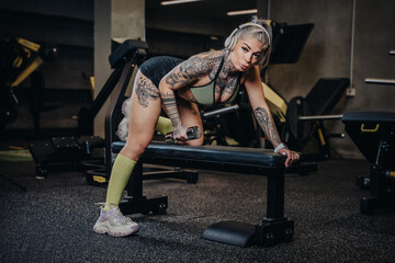 Fototapeta na wymiar sexy tattoo girl in the gym