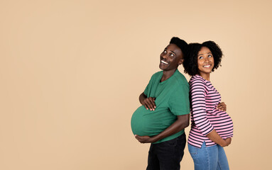 Happy young african american husband and pregnant wife with big belly in casual have fun together