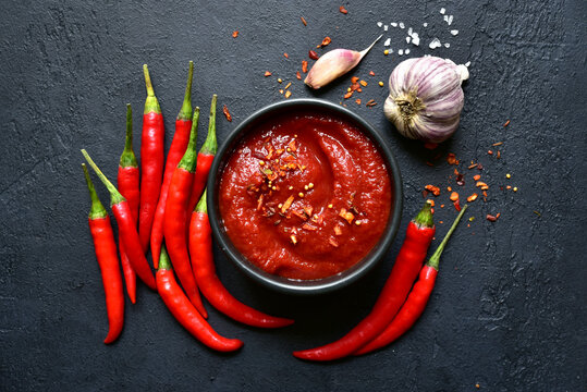 Spicy asian dip harissa with roasted red pepper and garlic.Top view with copy space.