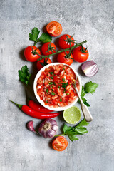 Tomato salsa (salsa roja) - traditional mexican sauce  with ingredients for making .Top view with copy space.