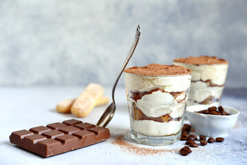 Tiramisu - traditional italian coffee dessert from mascarpone cheese and biscuit in a glass cup.