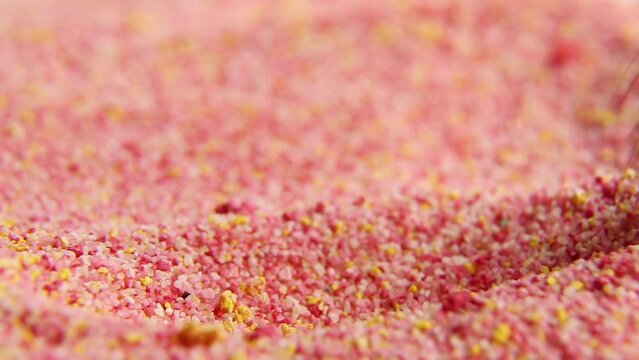 The red-yellow powder is stirred with a brush. A cosmetic brush stirs the crimson yellow powder. The colored substance is kneaded with a brush. Macro. ASM video