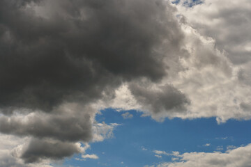 A terrible black cloud hangs in the sky before the rain. Bad weather. Hurricane and thunder over the city. Climate change and natural disasters. Bad mood and despondency.