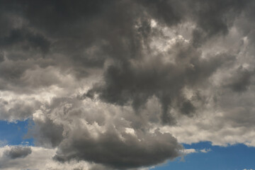 A terrible black cloud hangs in the sky before the rain. Bad weather. Hurricane and thunder over the city. Climate change and natural disasters. Bad mood and despondency.