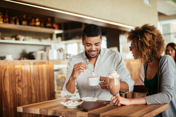 Young couple on a date in a cafe enjoying a cup of coffee
