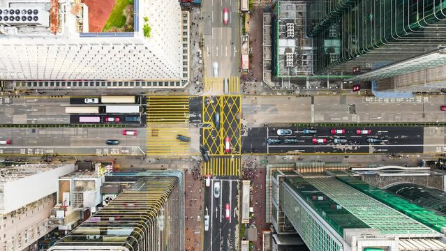 Hyperlapse Timelapse of car traffic transport on road junction intersection in Mong Kok, Hong Kong city downtown. Drone aerial top view. Asian people lifestyle, Asia city life or public transportation