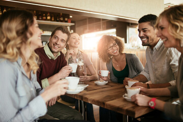 Group of young people enjoying a coffee in a cafe