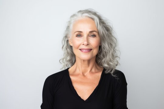 Portrait Of Smiling Senior Woman With Grey Hair Isolated On A White Background