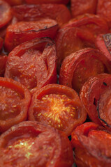 many fresh roasted tomatoes sliced, shallow depth of field