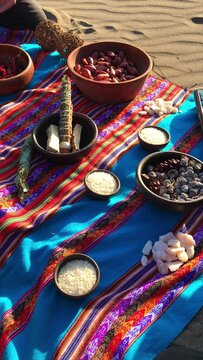 Mystical andean journey: peruvian blanket, charango, herbs, natural ingredients, crystals and burning holy wood incense in the desert sand