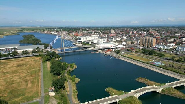 Southport, Lancashire, UK, June 21, 2023; High-level aerial flying and orbital clip video footage of the Marine Lake and Millennium Bridge in Southport, England