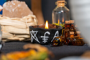 Black magic candles witchcraft composition. Magic ritual satanic tools and items. Halloween and occult black magic ritual imaginary. Ritual scene in dark and frightening atmosphere.