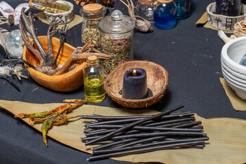 Magic liquid spell potion in the glass vials with black witchcraft candles. Mysterious witch fairy scene. Witch craft ritual background. Halloween holiday still life mystic background esoteric objects