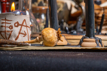 Still life with witchcraft bottles and burning candles lights. Vials with dry weeds and herbs for...