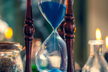 Sand move through hour glass. Close up of hourglass clock selective focus. Old time classic...