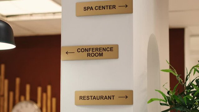 Empty stylish business accommodationlobby interior with luxurious deluxe conference room, spa center and restaurant amenities. Close up of hotel facilities plaque signs on resort lounge wall