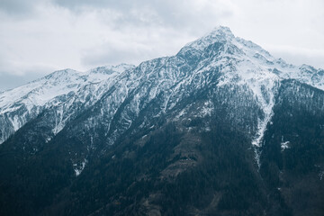 Fototapeta na wymiar mountain peaks in gray clouds. Mountain landscape.Mountains and sky in gloomy blue tones. mountain landscape.Hohe Tauern region.Tyrol,Austria.