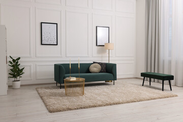 Stylish living room with soft beige carpet, coffee table and sofa. Interior design