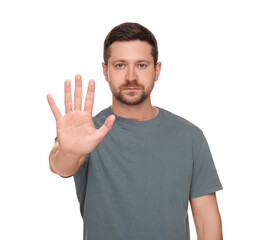 Fototapeta premium Handsome man showing stop gesture isolated on white