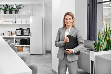 Happy real estate agent with leather portfolio indoors