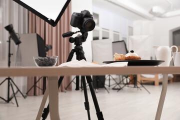 Professional equipment and composition with delicious dessert on wooden table in studio. Food photography