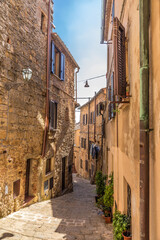 Fototapeta na wymiar Volterra, Italy. Colorful narrow street of a medieval city