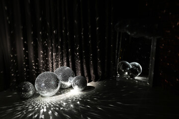 Many shiny disco balls in dark room