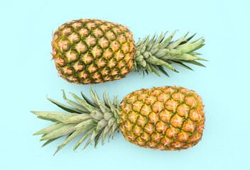 Fototapeta premium Delicious ripe pineapples on white background, top view