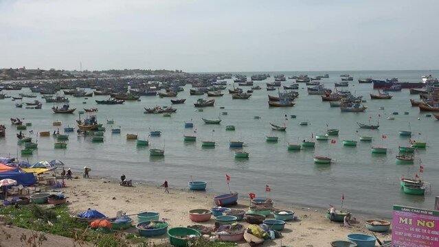 Vietnamese Fishing Village and many boats in the sea collecting seafood all day