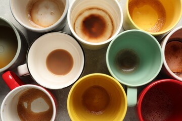 Many dirty cups after different coffee drinks on light grey table, flat lay