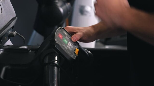 Treadmill buttons, Workout programs, Custom settings. Control panel treadmill being operated by man's hands pressing buttons.