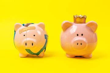 Two piggy bank. Budget of coronation ceremony, impoverishment of spending monarchy. Teaching financial literacy from bankruptcy, impoverishment to success. Passive income, profitable investment advice