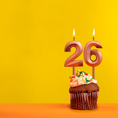 Candle with flame number 26 - Birthday card on yellow background