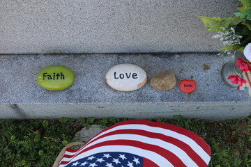 Faith and Love on rocks on gravestone