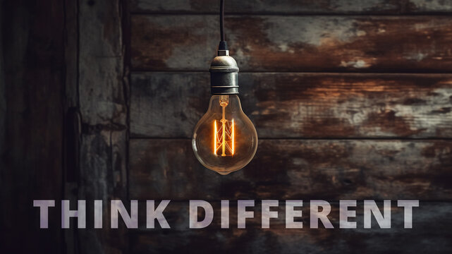 Illustration of a retro light bulb in front of a rustic background with text "think different" on it