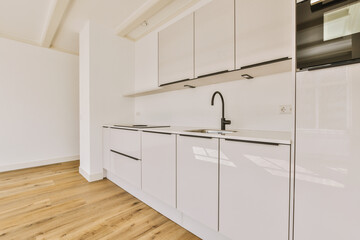 a kitchen with white cabinets and black appliances on the counters in front of the sink is empty, but there is no one
