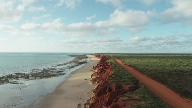 Coastal Kimberley region of Australia red dirt and ocean. Abstract aerial drone James Price Point Broome 4K.