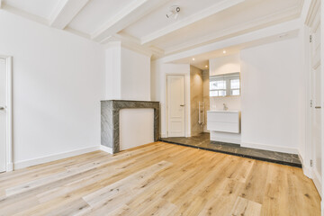an empty living room with wood flooring and white walls in the room is well lit by the light coming through the window