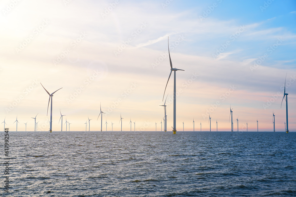 Wall mural offshore windmill farm. windmills isolated at sea on a beautiful bright day netherlands. green energ