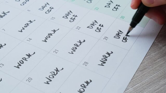 4 day work week printed calendar with weekend days four day working week concept. Female hand writing planning Modern approach doing business short workweek. Effectiveness of employees. Productivity