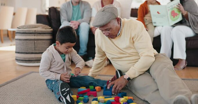 Family, building blocks and a granddad playing with his grandson in the living room during a home visit. Children, love or learning with toys with senior man bonding with his boy grandkid on a floor