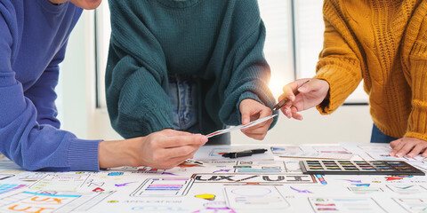 Close up ux developer and ui designer brainstorming interface wireframe design.Creative digital...