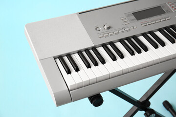 Fototapeta premium Modern synthesizer on blue background, closeup