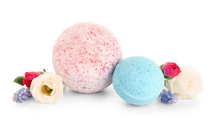 Bath bombs with flowers on white background
