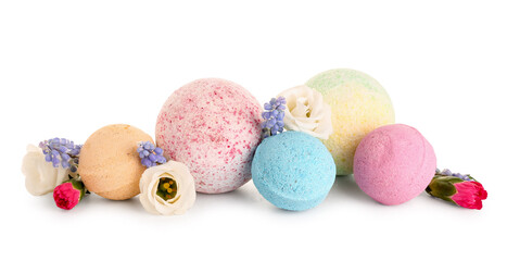 Bath bombs with flowers on white background