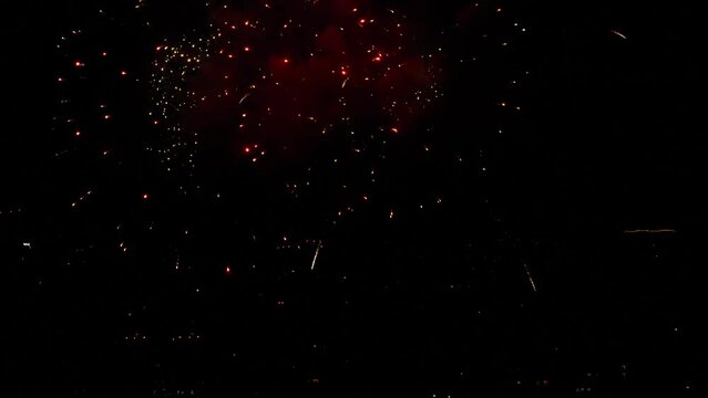 Multicolored fireworks in the night sky. Celebration of the event. New Year's and Christmas