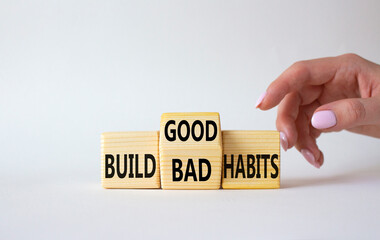 Build Good or Bad Habits symbol. Businessman hand points at wooden cubes with words Build Bad Habits vs Build good Habits. Beautiful white background. Business concept. Copy space