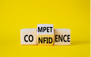 Competence and Confidence symbol. Wooden cubes with words Confidence and Competence. Beautiful yellow background. Business concept. Copy space